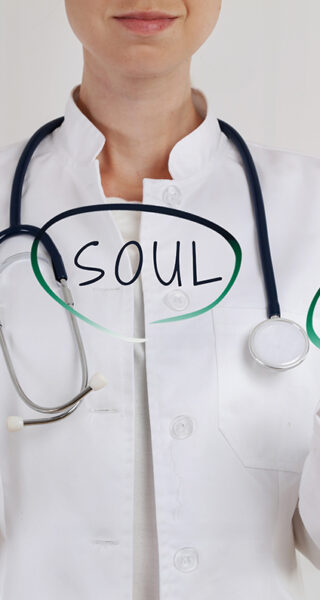a doctor holding a sign of balancing body, soul, mind